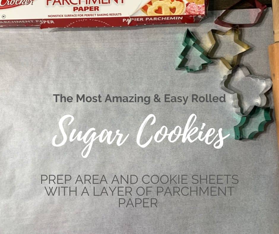 Prepare area and cookie sheets by laying out parchment paper and lightly dusting with flour to make rolling and cutting the sugar cookies easier!