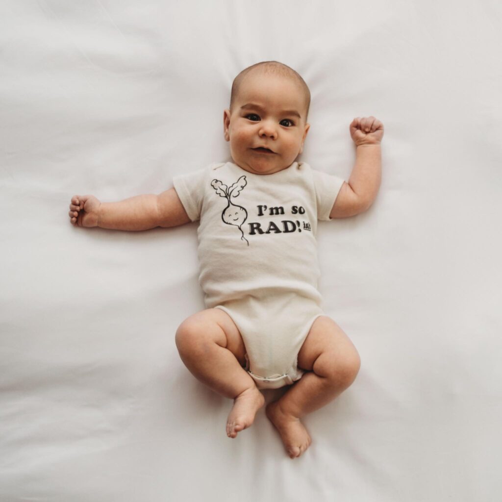 Baby boy wearing onesie that says I'm so radish - funny vegetable pun