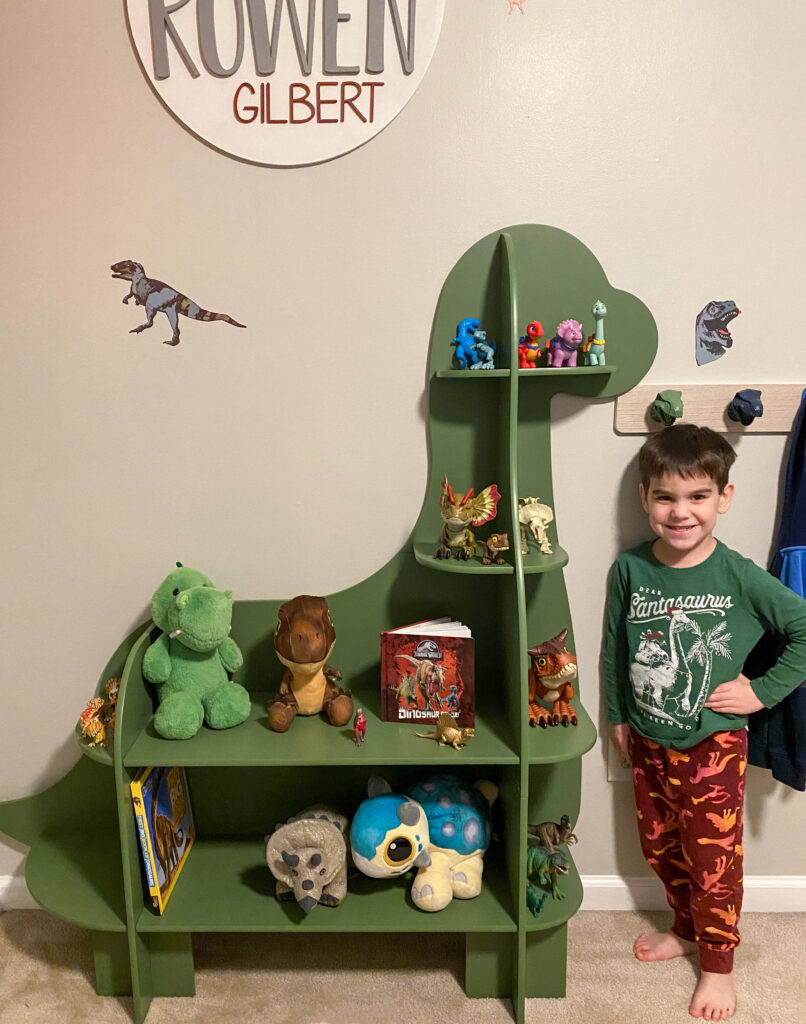 green dinosaur shelf in little boys bedroom