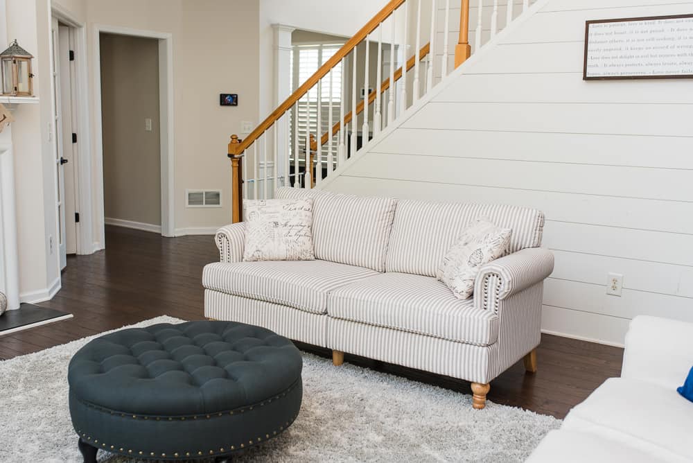 neutral-accent-sofa-and-dark-tufted-ottoman